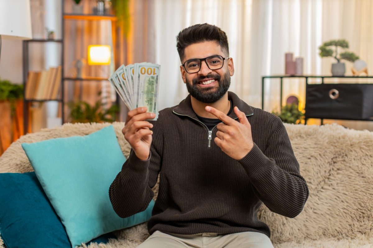 man holds cash from payday loan