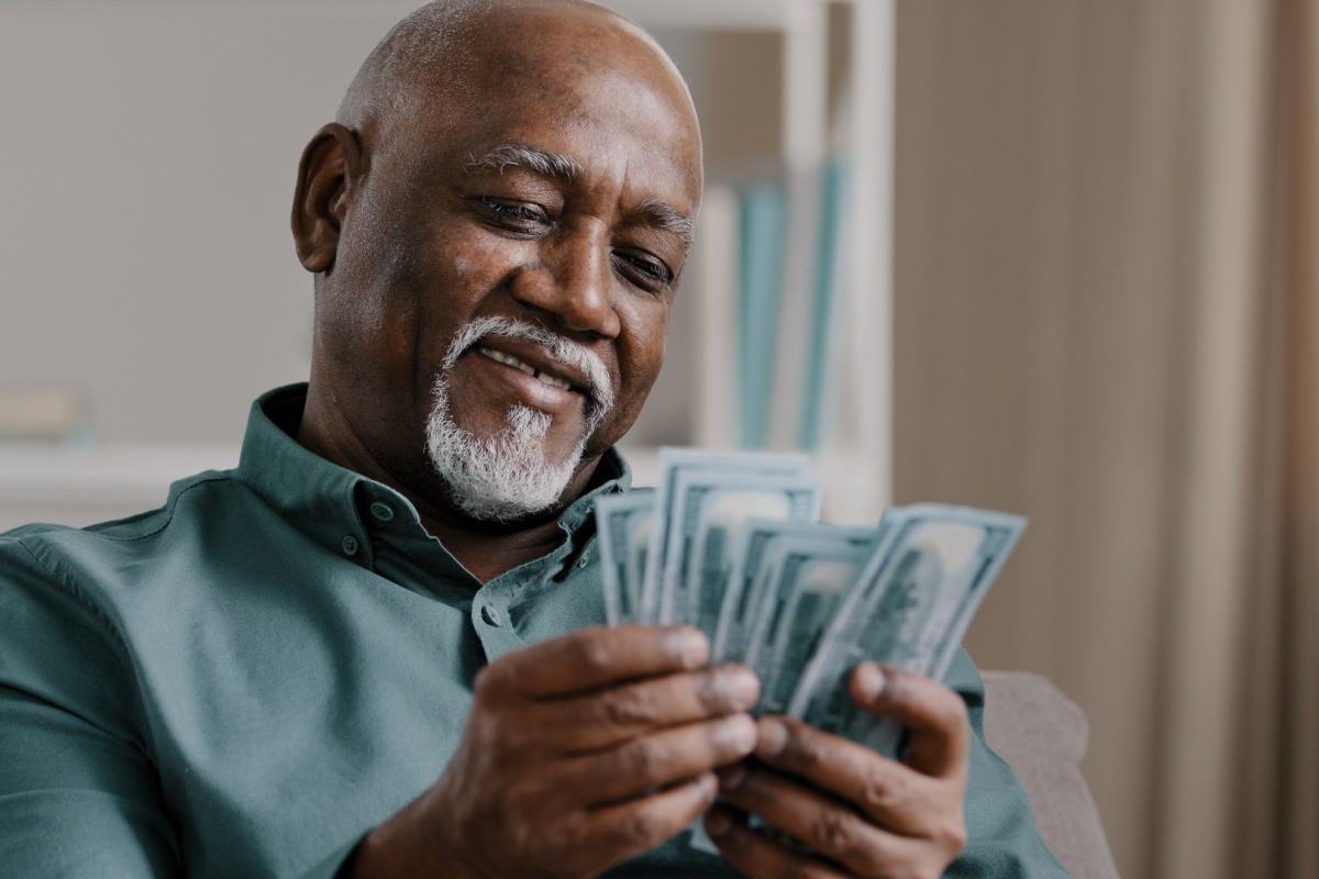 man holds cash from personal loan