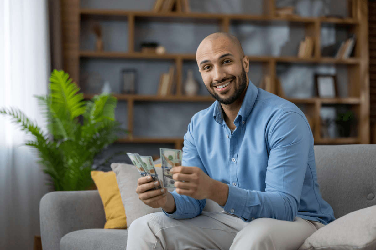 man holds cash from a registration loan in Arizona