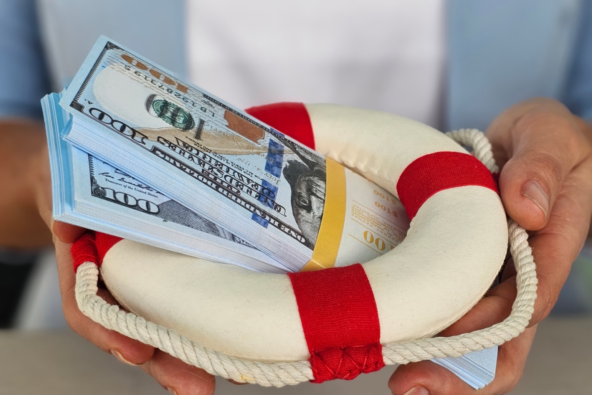 man holds emergency cash from loans in Wisconsin