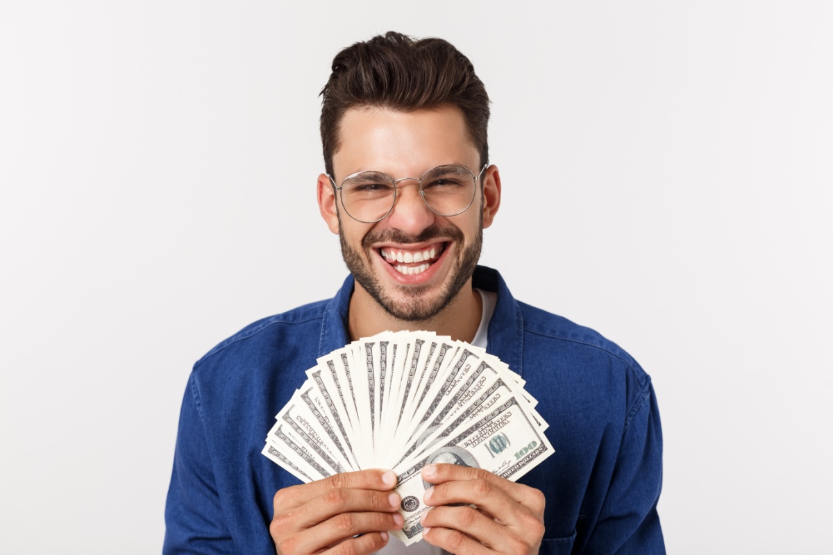 man holds title loan cash