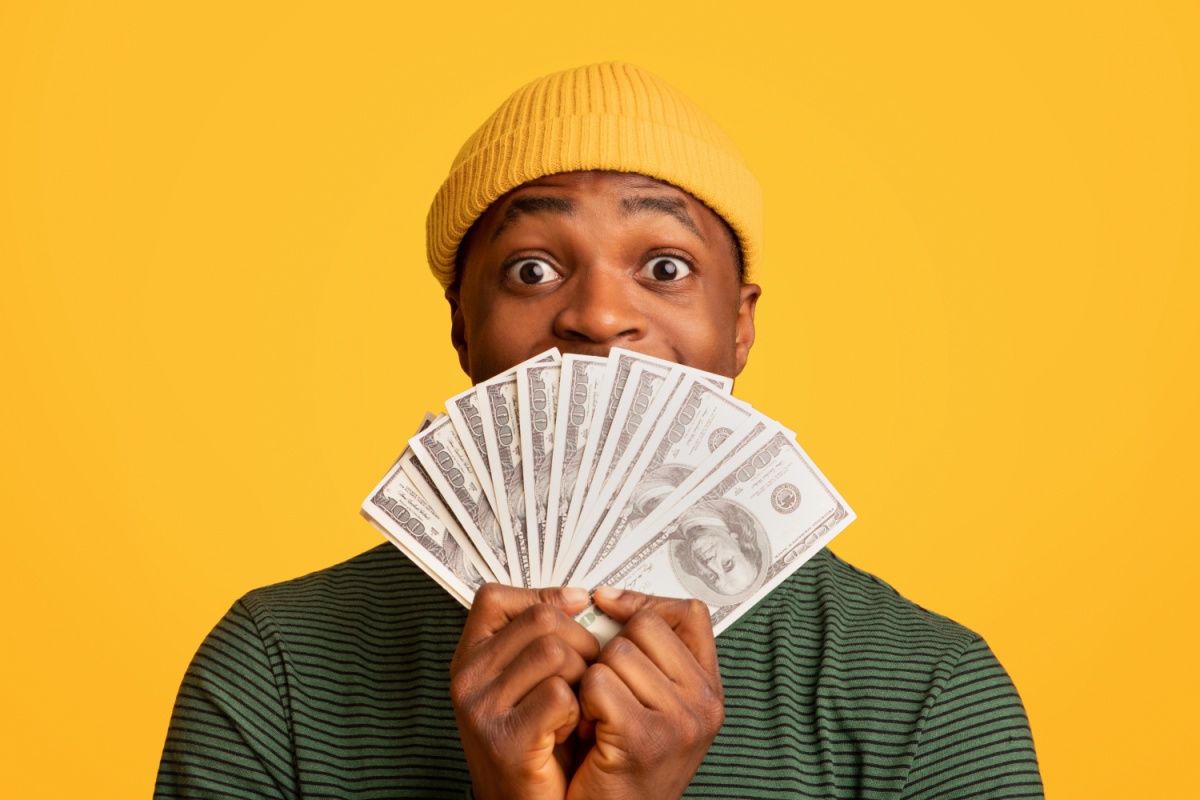 man with bad credit holding cash from same day loan