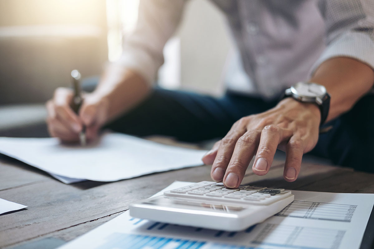 man using calculator for finances