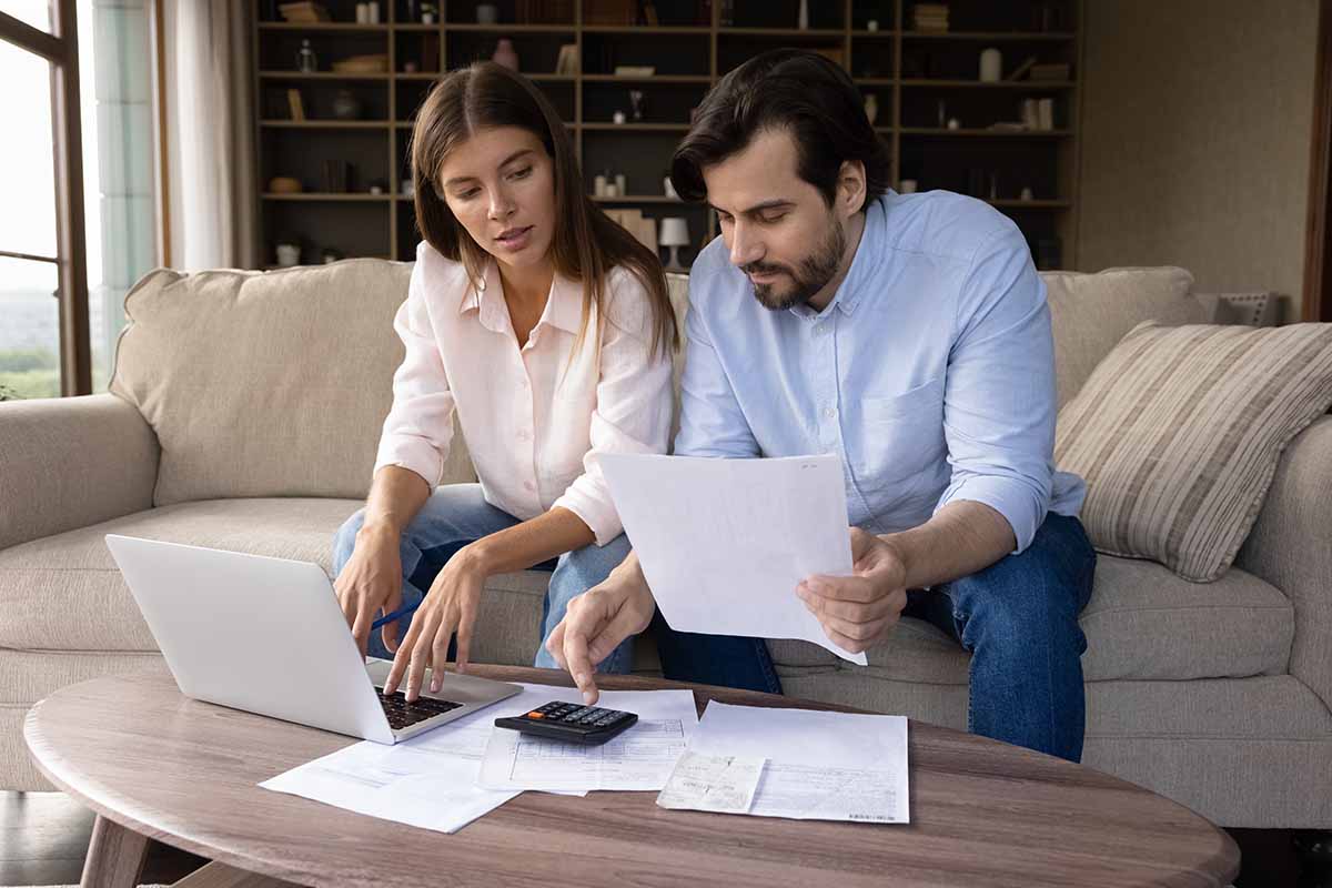 couple working on monthly budgeting with using registration loan plan