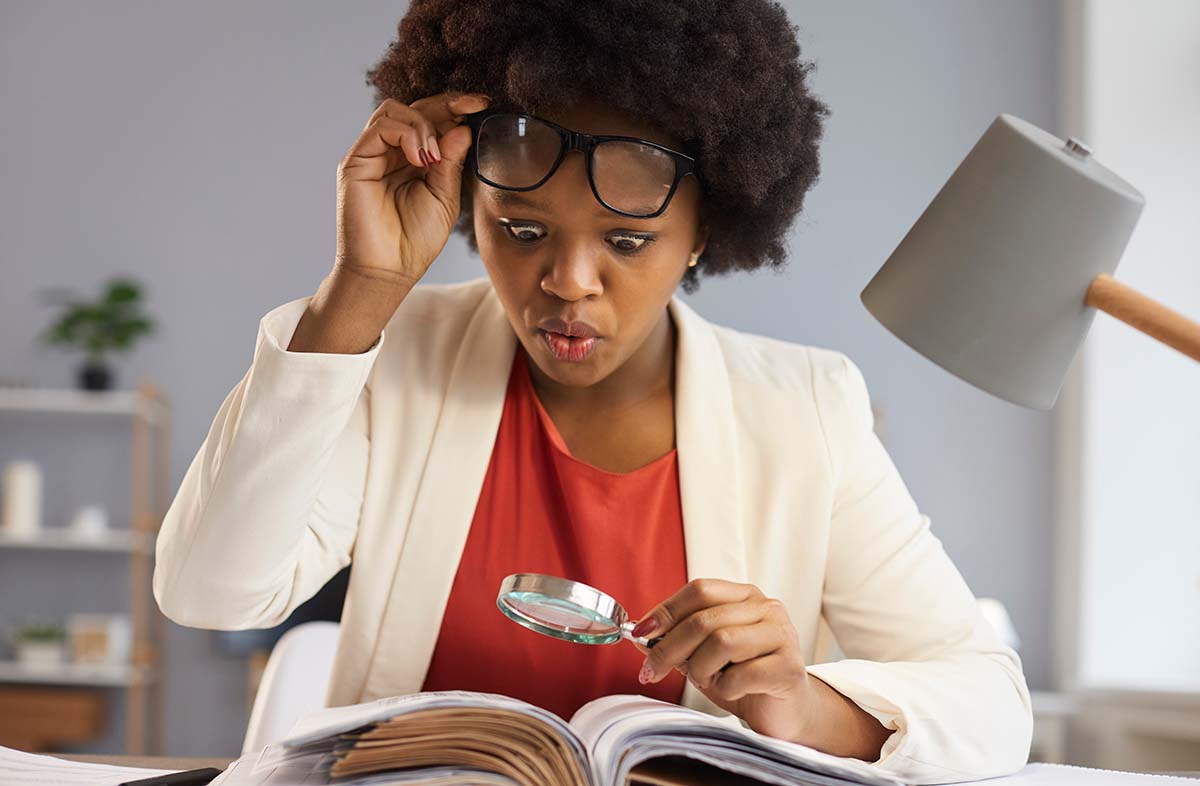 woman looking at textbook for financial facts you should know