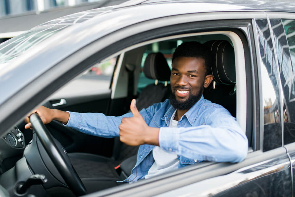 man in car happy from receiving title pawn from Georgia Auto Pawn, Inc.