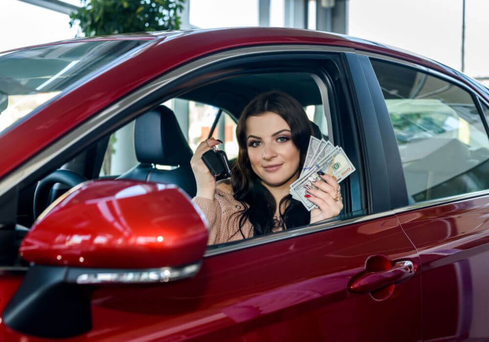 woman with car and title loan money