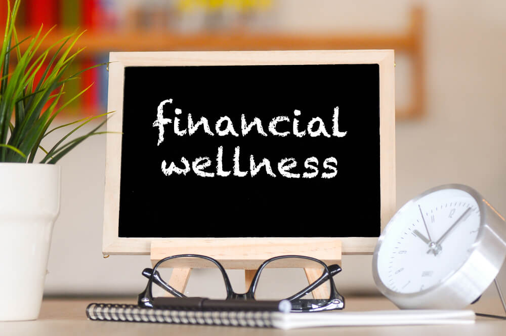 writing down tips for financial wellness