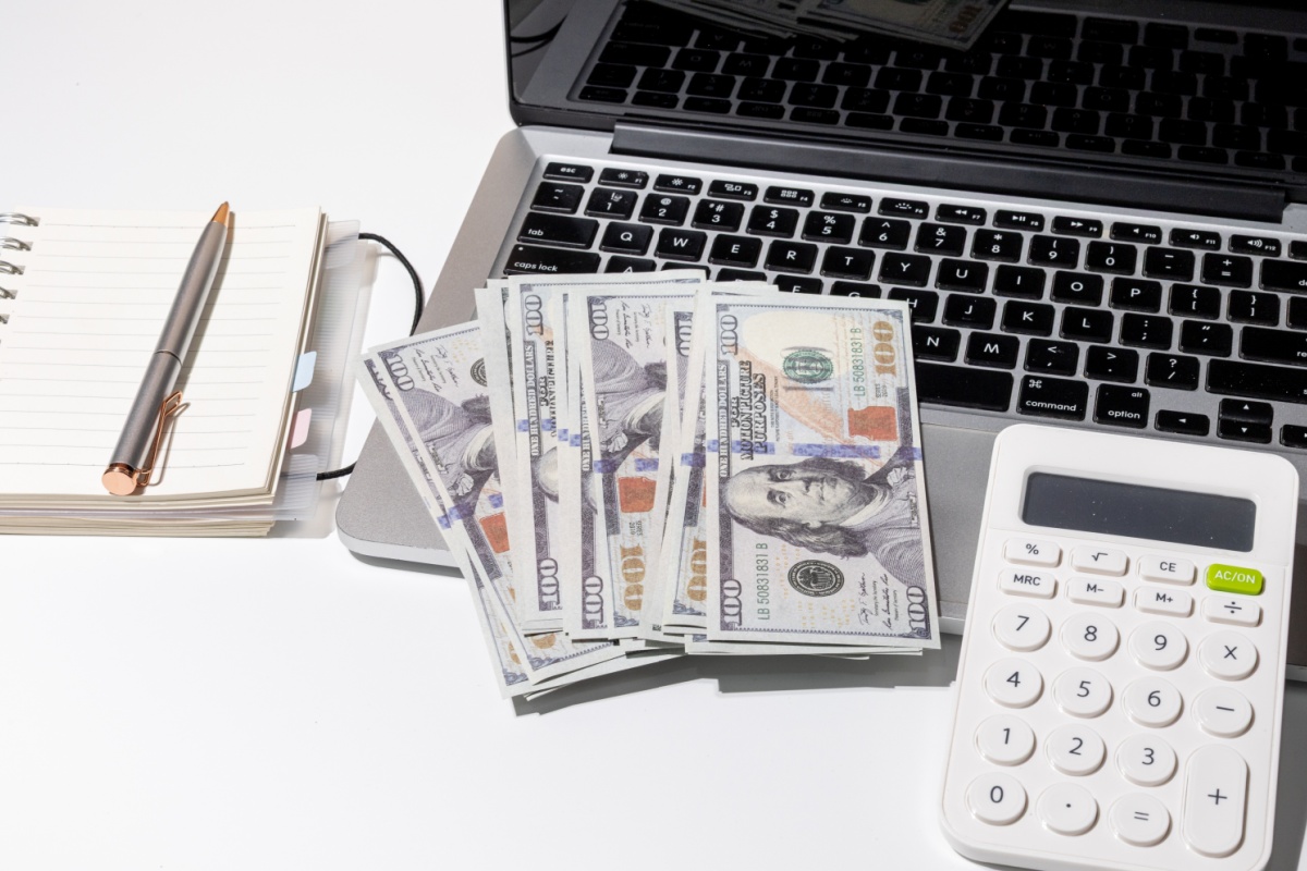 online payday loans cash sitting on laptop