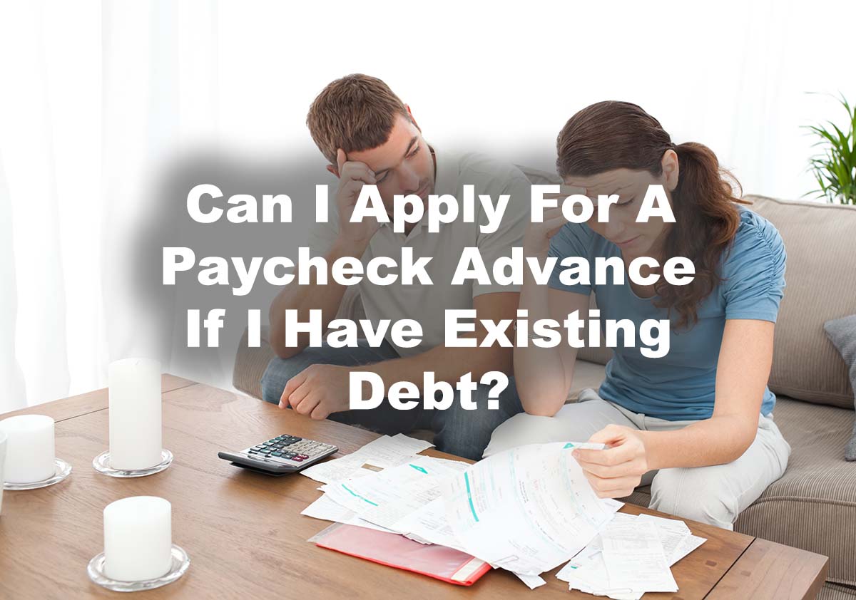 couple looking a debt and reviewing payday loan and text Can I apply for a Paycheck Advance if I have debt?