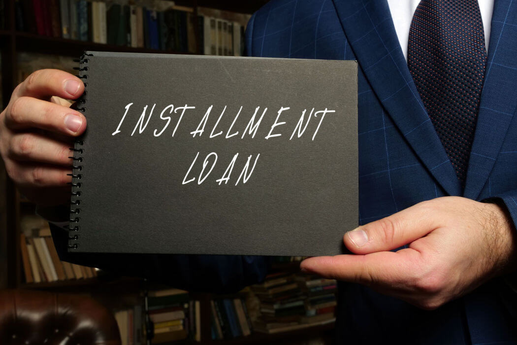 man holding installment loan sign