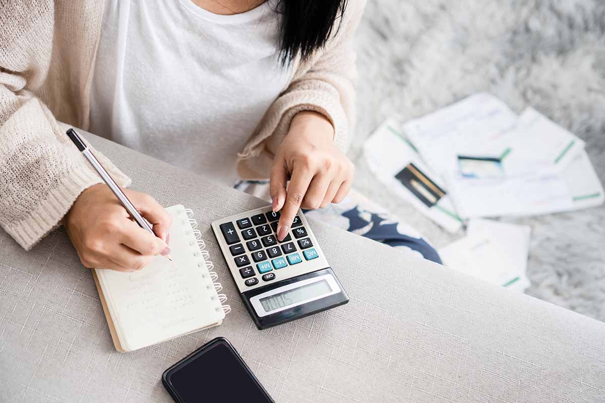 woman with calculator reviewing finances