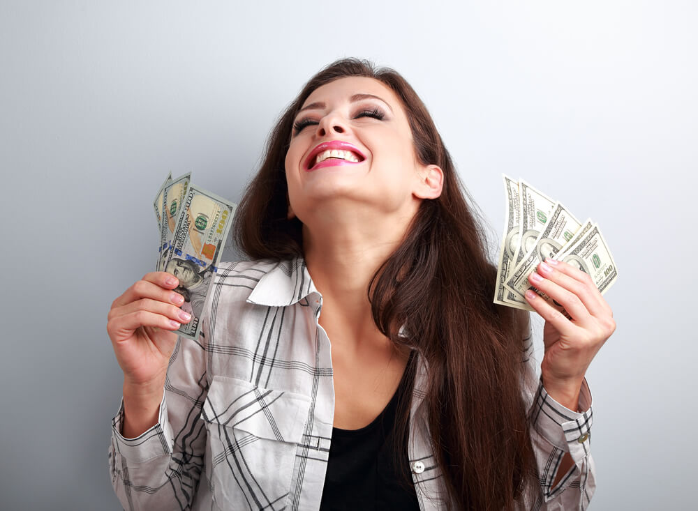 woman excited from online title loans no store visit and holding cash