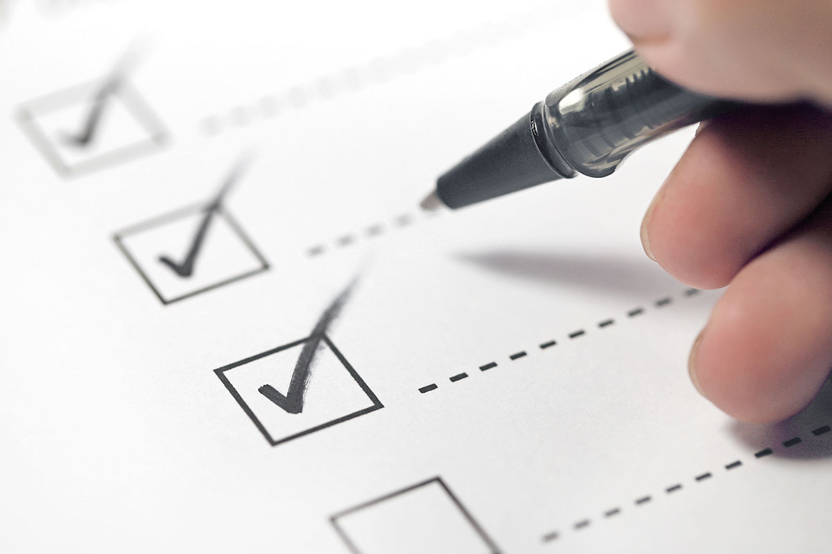 person checking off registration loan checklist