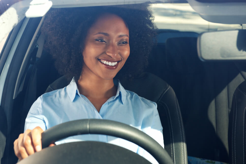 happy woman in car after getting Prescott Valley title loan