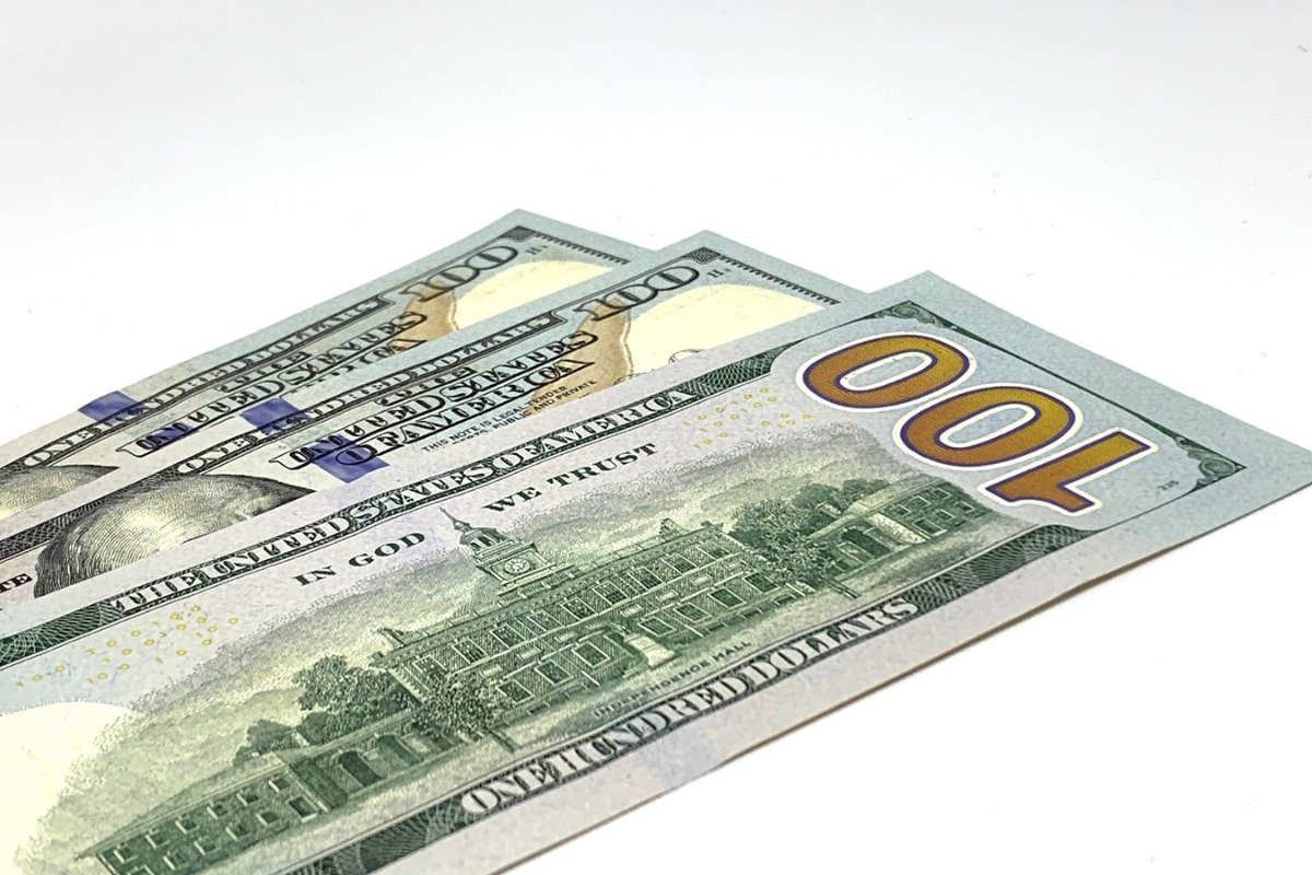 three 100 dollar bills