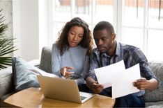 Couple reviewing emergency expenses and need title loan near them for help