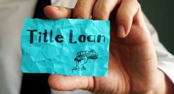 A person holding up a post-it note related to same-day title loans.