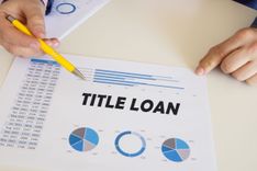 woman completing paperwork for title loan for financial emergency 