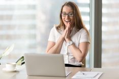 woman happy from receiving online car title loans in Las Vegas from the comfort of her office