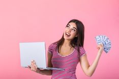 woman happy and holding cash from auto title loans in Avondale, AZ