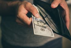 Man putting payday loans cash in wallet in reno, nv