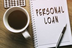 note pad that reads same day personal loans, cup of coffee and calculator