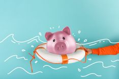 piggy bank in life raft for getting a title loan for financial emergency