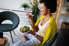 woman eats salad on a healthy living budget