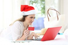 woman looking at holiday debt and reviewing title loan online