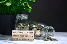 Jars filled with coins from short term financial goals