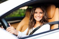 woman in car waiting for inspection for title loan 