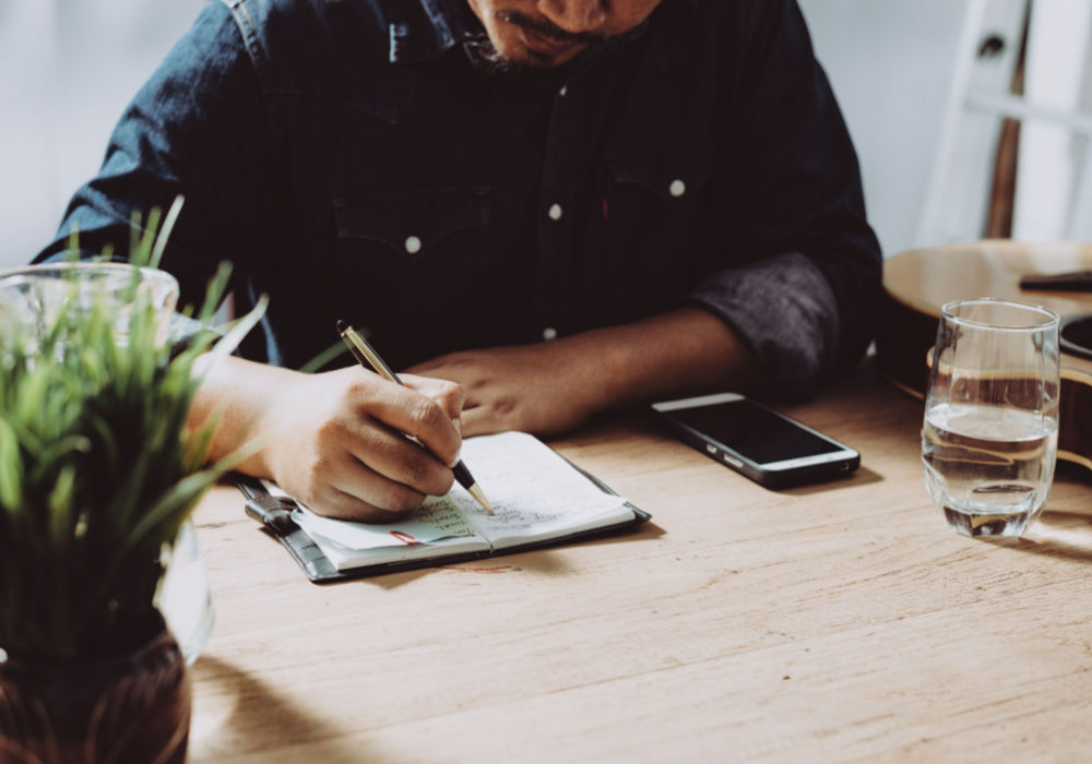 man working on title loan checklist