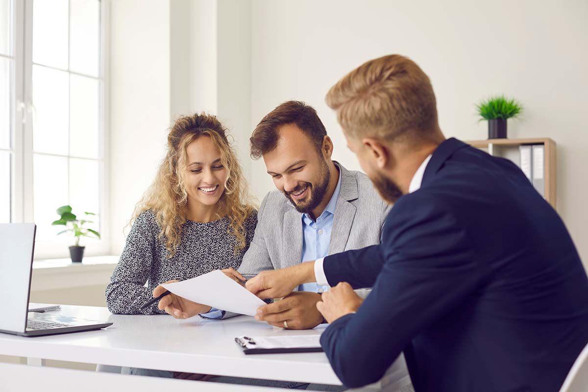 couple going through title loan paperwork at their home with representative