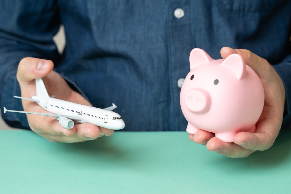 toy airplane and piggybank with money from a payday loan