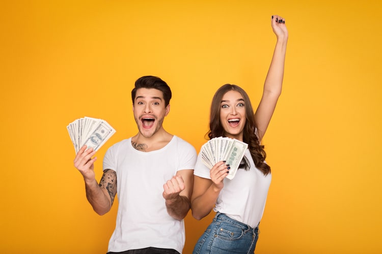 couple holding title pawn cash