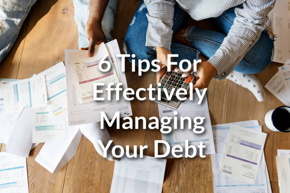 person on floor going through paperwork to manage their debt