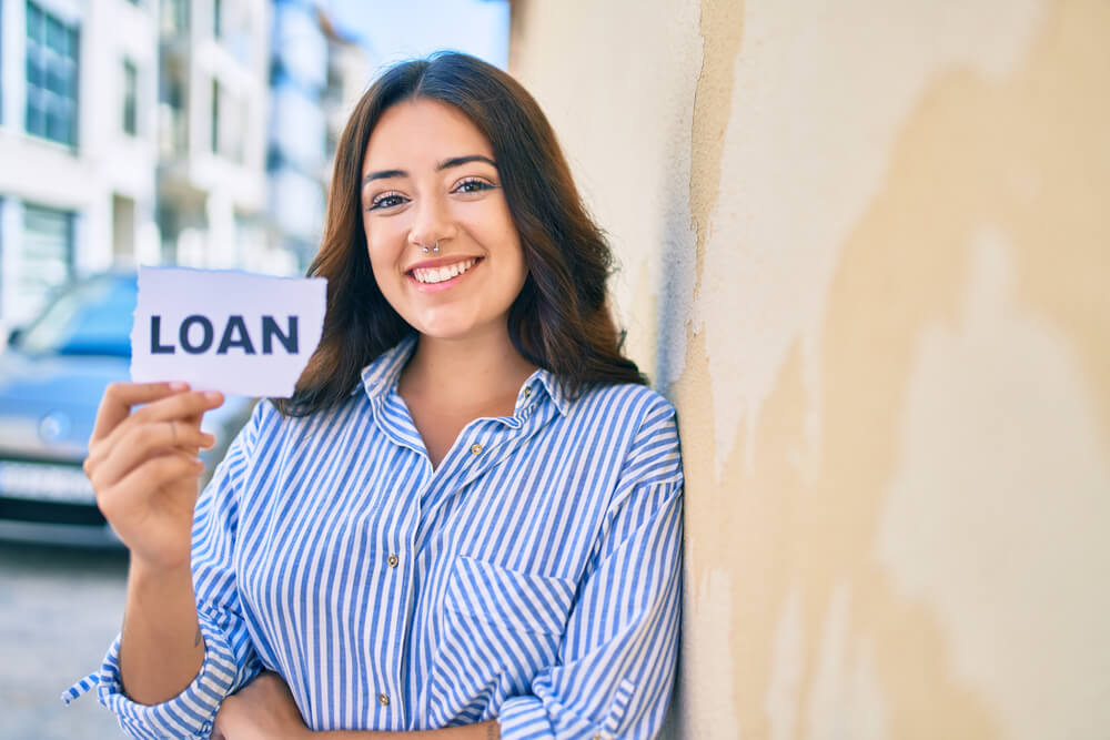 happy woman holding sigh for title loan