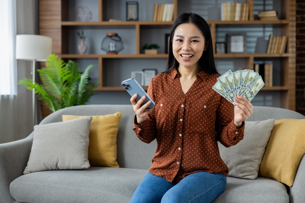 woman holding cash from car equity loan