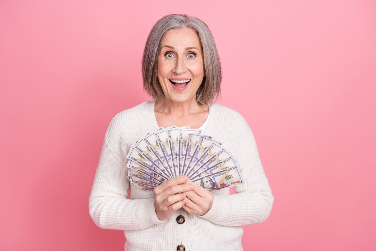 woman holding title loan cash