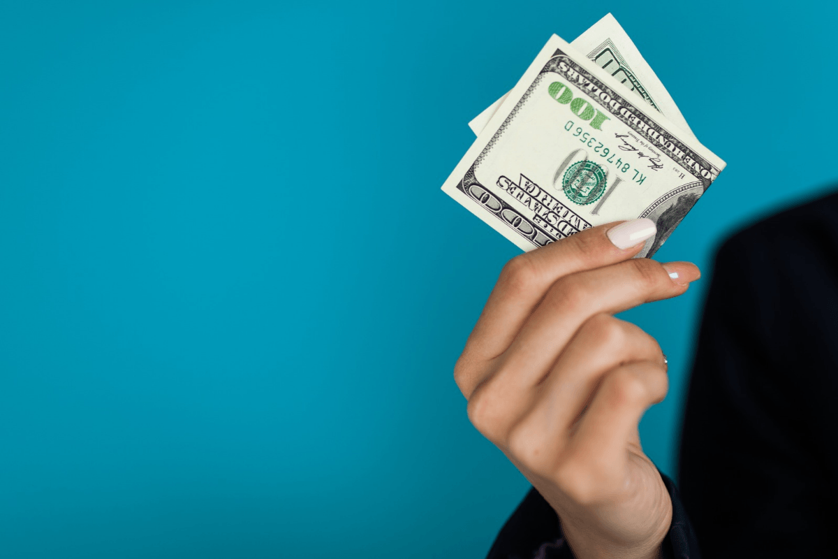woman holds a $100 cash advance