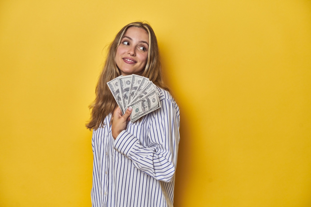 woman holds new job cash advance money