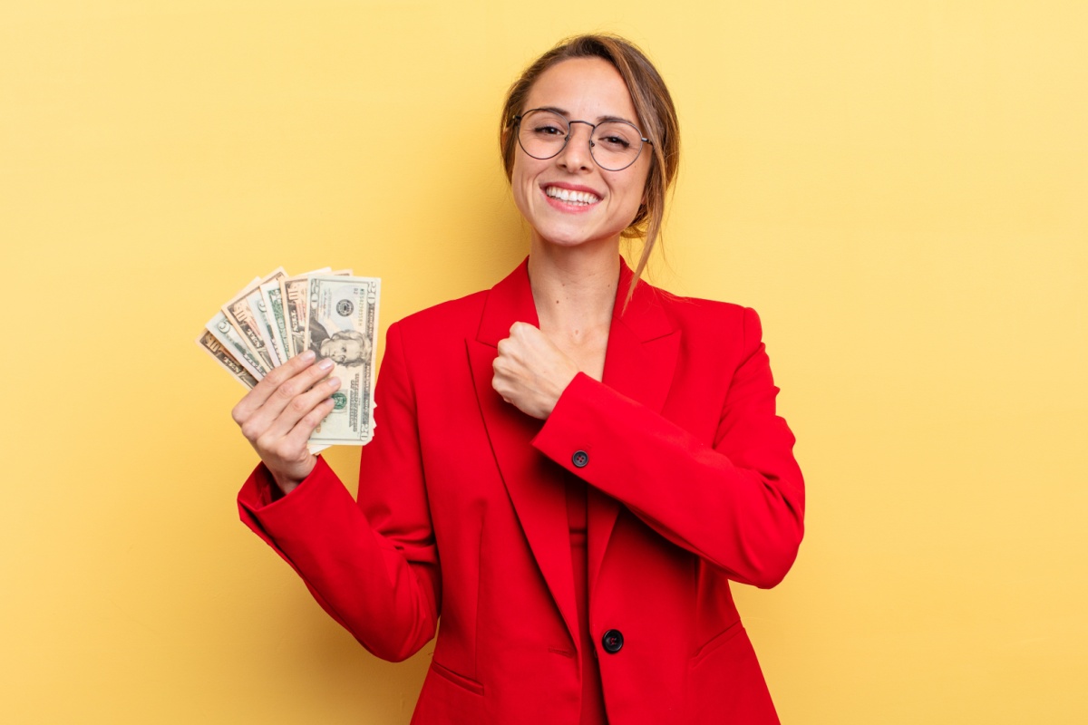 woman smiling and holding payday loan cash