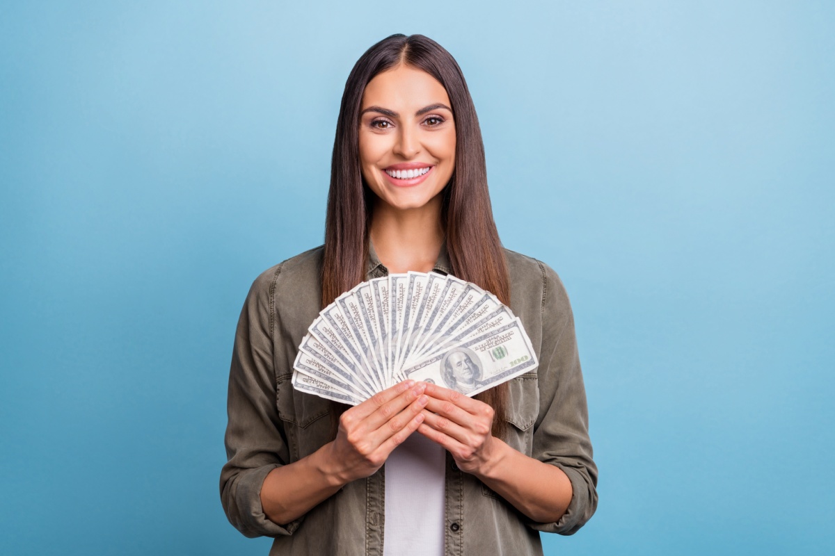 woman holds title pawn cash
