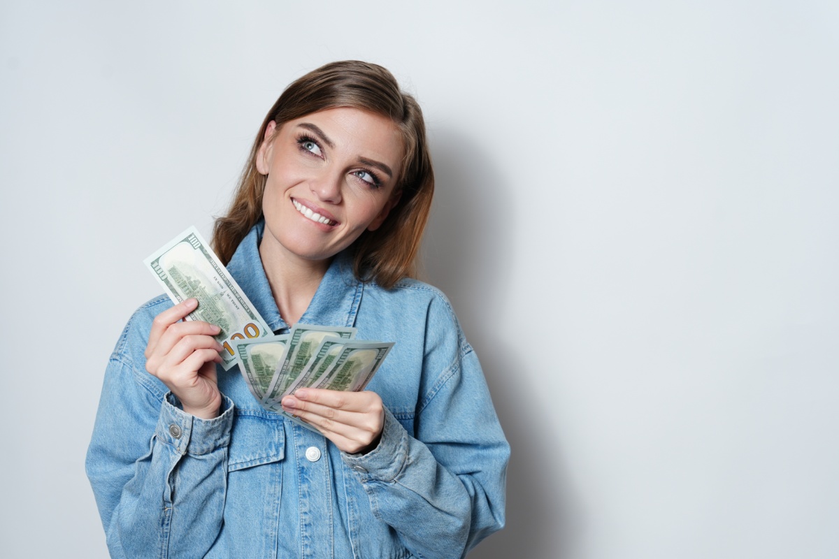 woman holds title pawn cash
