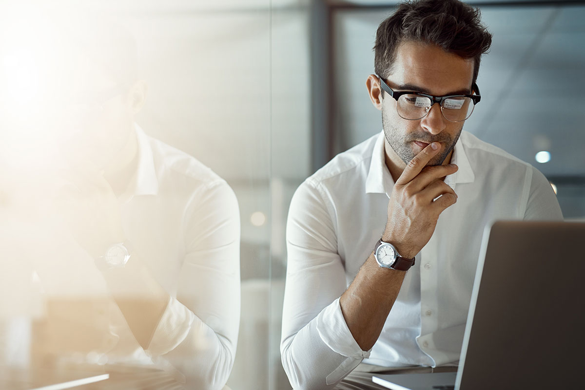 The image shows a man stares at his laptop, searching for the definition of title loans