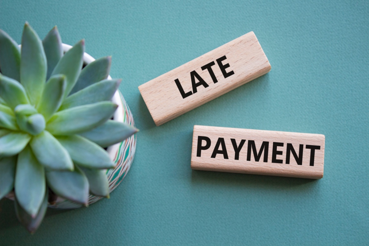 wooden blocks that say late payment
