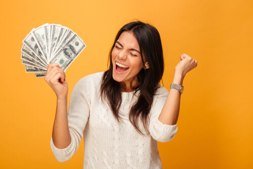 girl holding car title loan cash