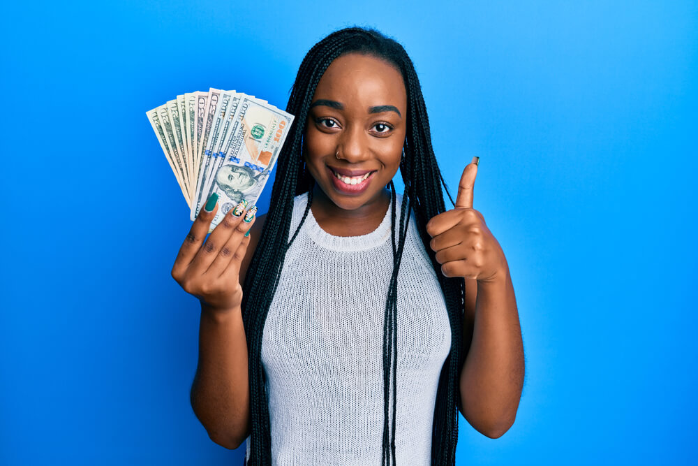 woman with title pawn cash giving a thumbs up