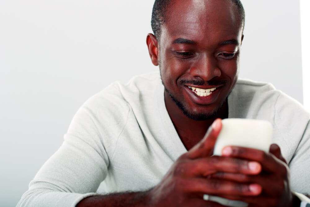 man using phone for online payday loan